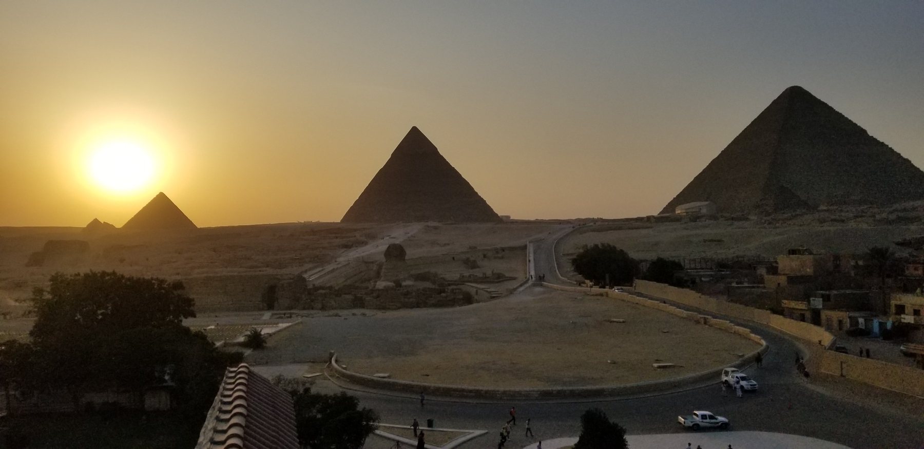 Sun setting beside the Pyramids of Giza