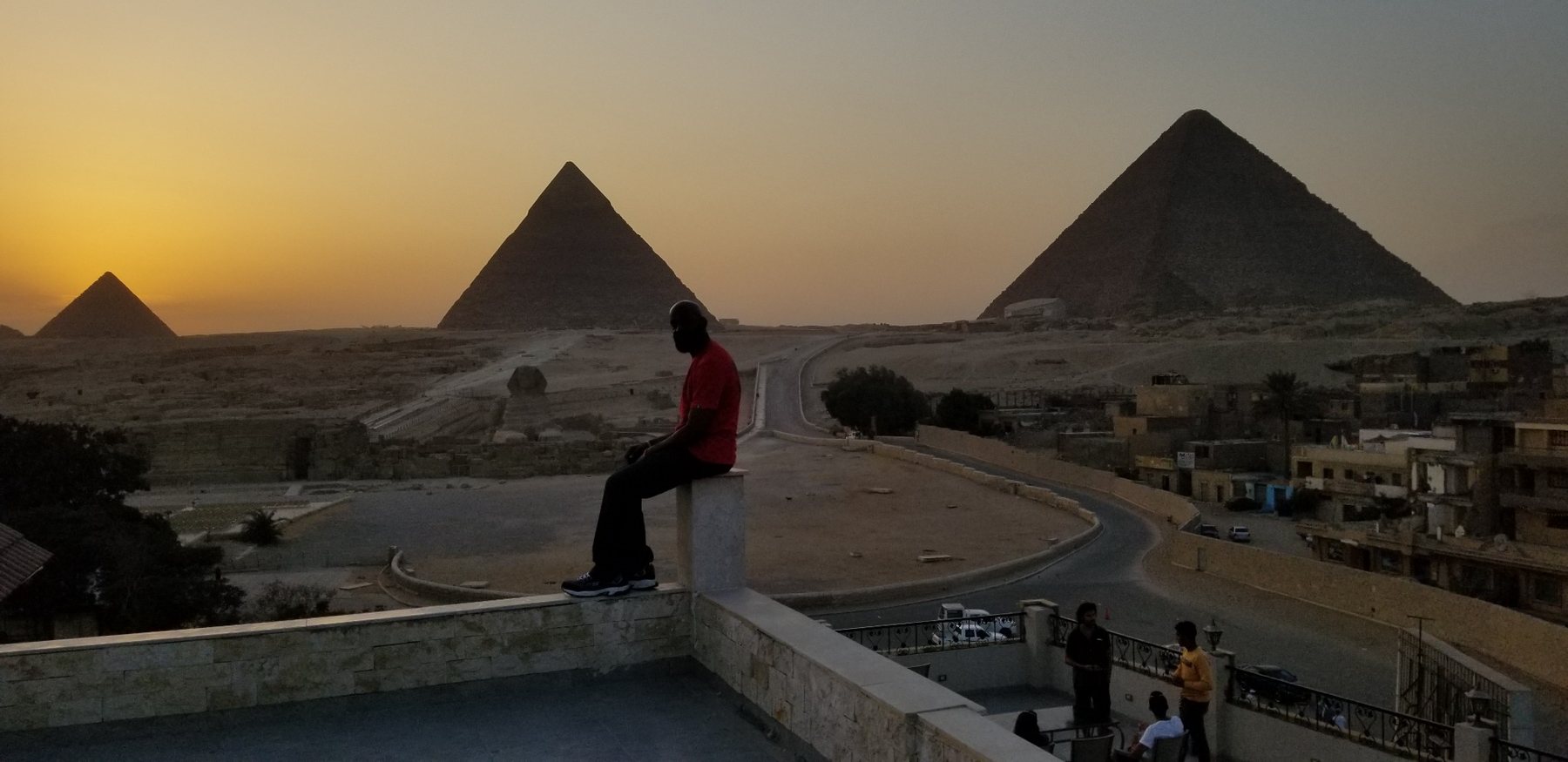 Darnell overlooking the pyramids at sunset