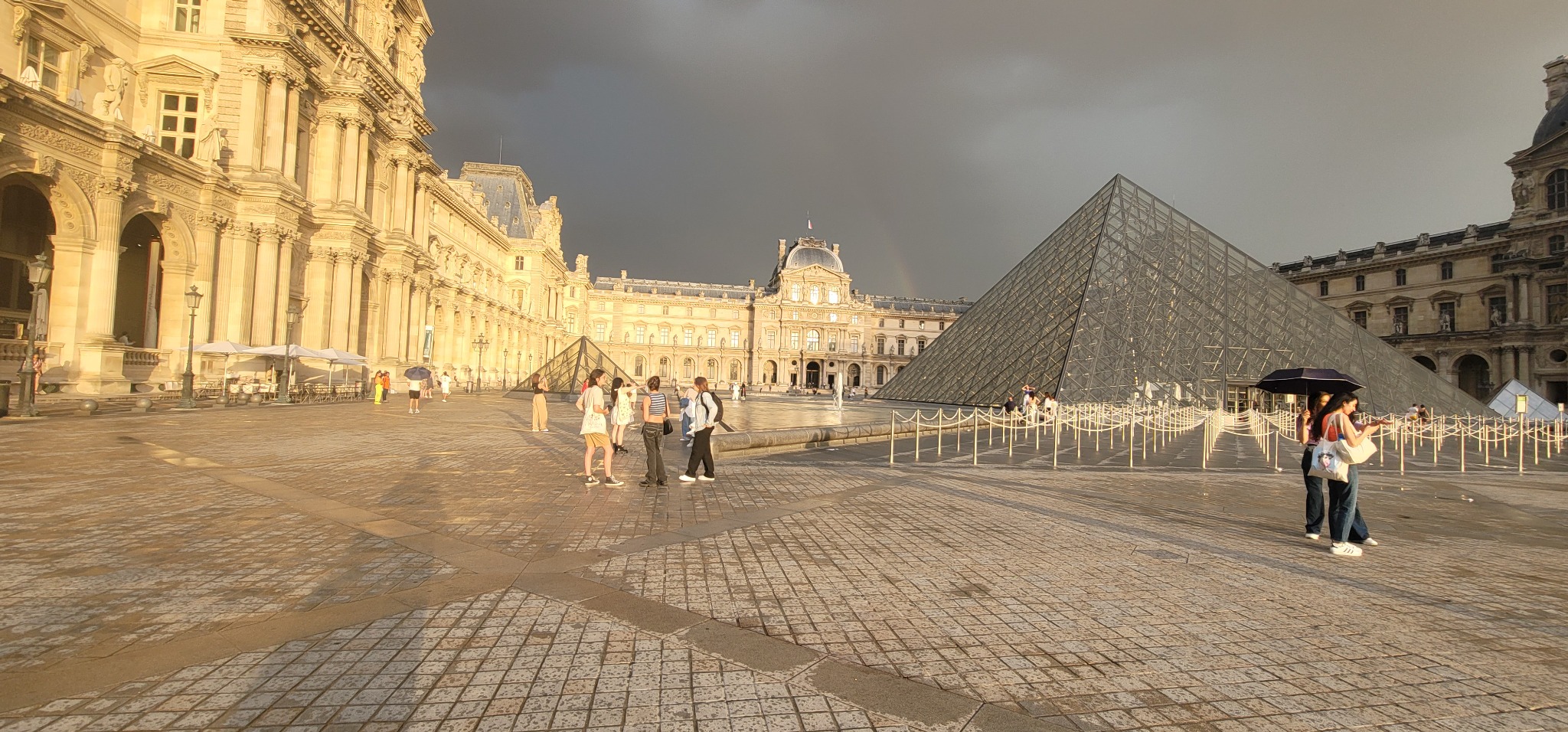 Louvre Pyramid and palace in warm evening light