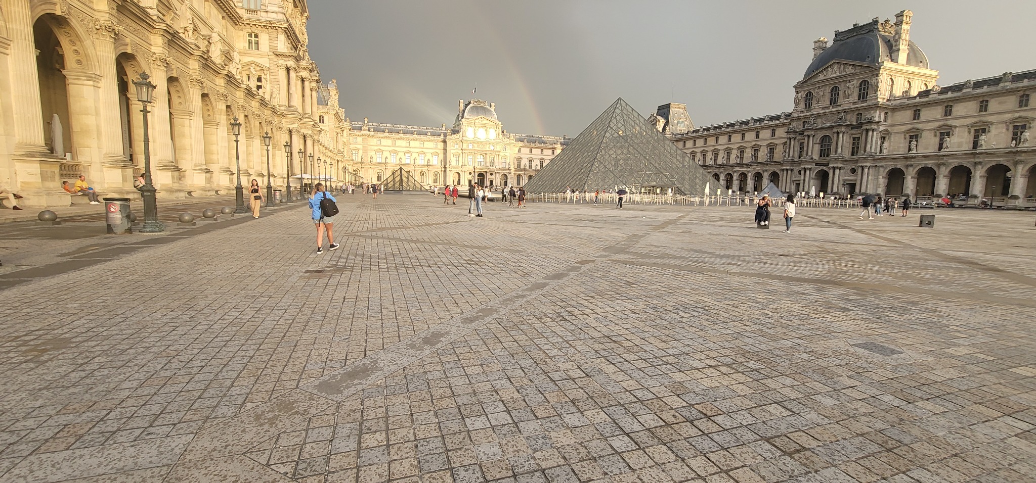 Wide view of the Louvre courtyard and glass pyramid